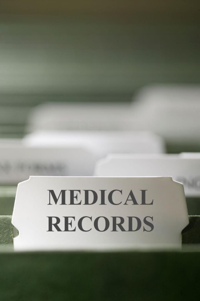 doctor reviewing patient medical records during insurance claim assessment