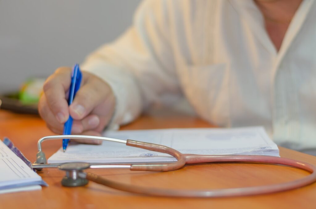 Doctor correcting discharge summary for insurance claim approval