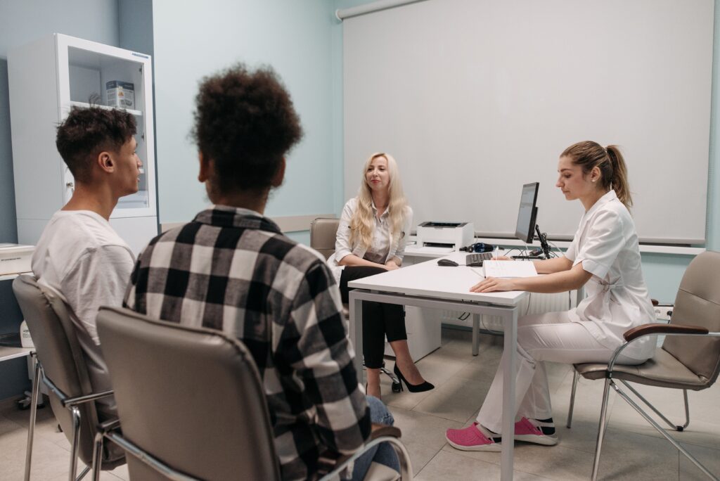 Patient discussing insurance claim documents with hospital administration staff